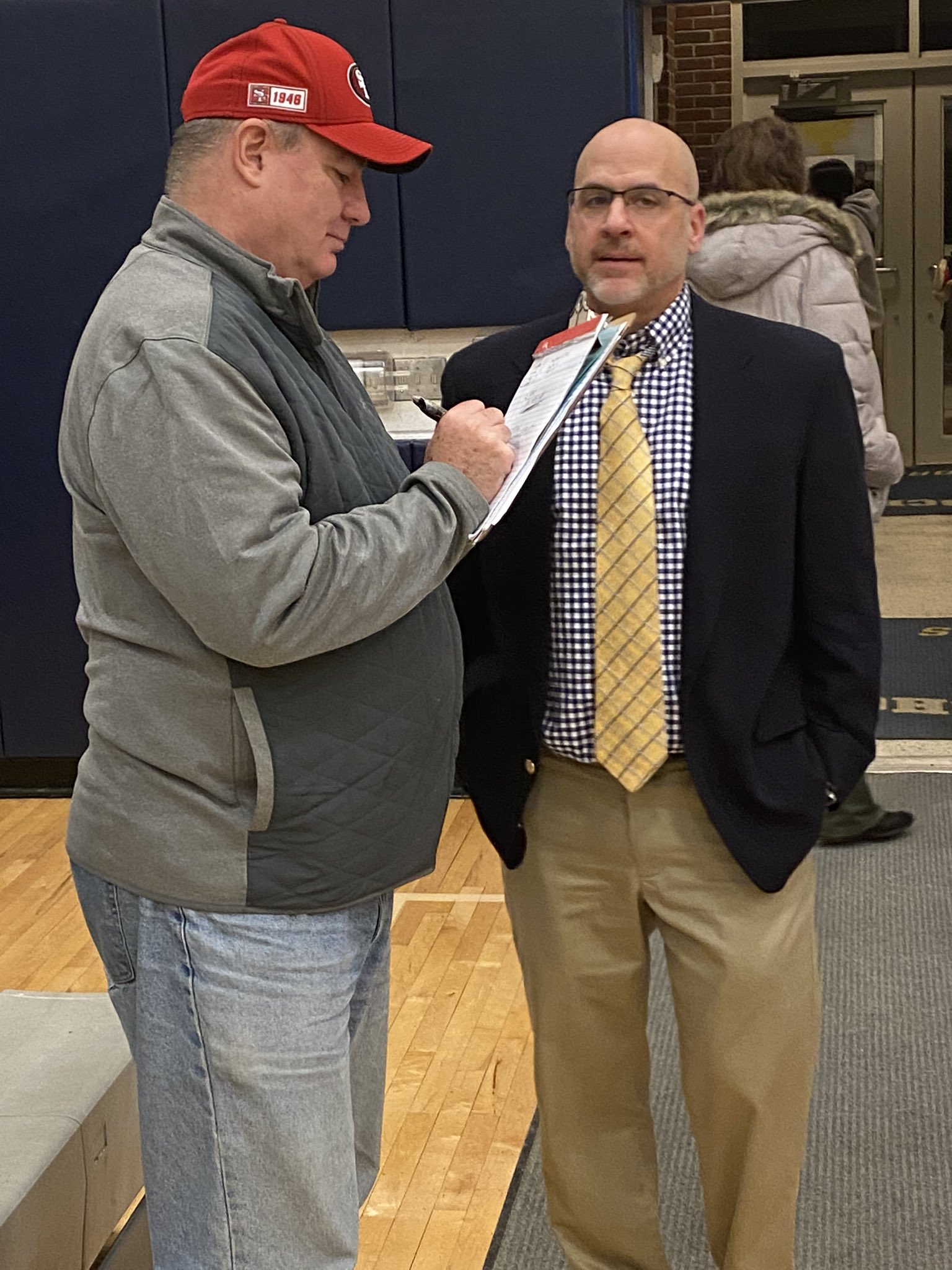 coach talks with a reporter