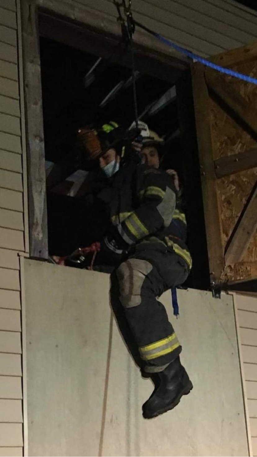 firefighter coming out of window